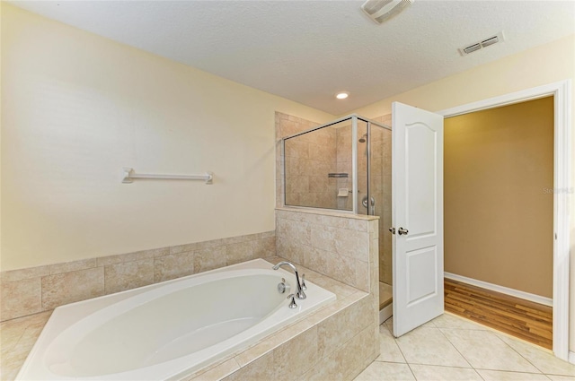 1912 Hawks View Dr, Ruskin, FL 33570 - full bathroom featuring tile patterned floors, visible vents, a garden tub, and a stall shower