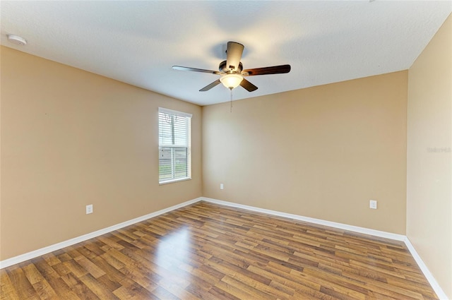 1912 Hawks View Dr, Ruskin, FL 33570 - empty room with a textured ceiling, baseboards, a ceiling fan, and wood finished floors
