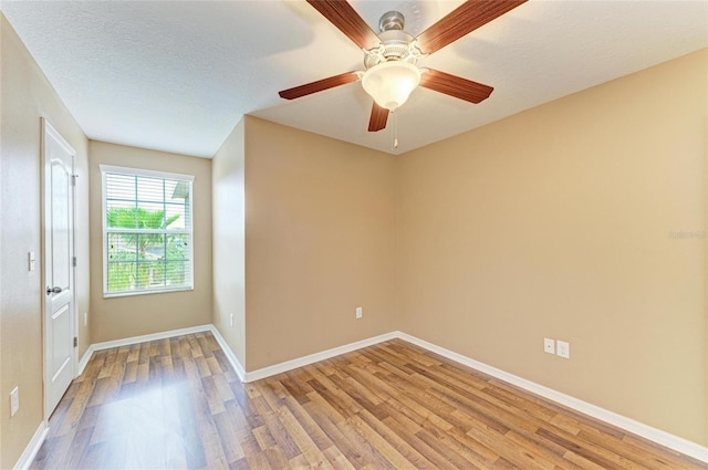 1912 Hawks View Dr, Ruskin, FL 33570 - empty room with baseboards, ceiling fan, light wood-style floors, and a textured ceiling