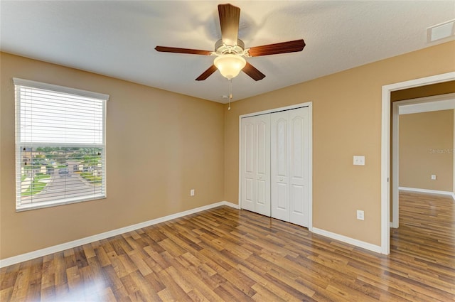 1912 Hawks View Dr, Ruskin, FL 33570 - unfurnished bedroom with a closet, a ceiling fan, visible vents, wood finished floors, and baseboards
