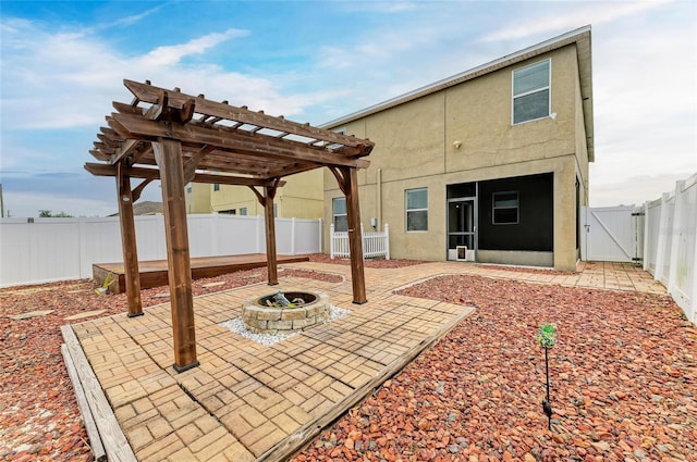 1912 Hawks View Dr, Ruskin, FL 33570 - back of house featuring a pergola, a fenced backyard, stucco siding, a patio, and a gate