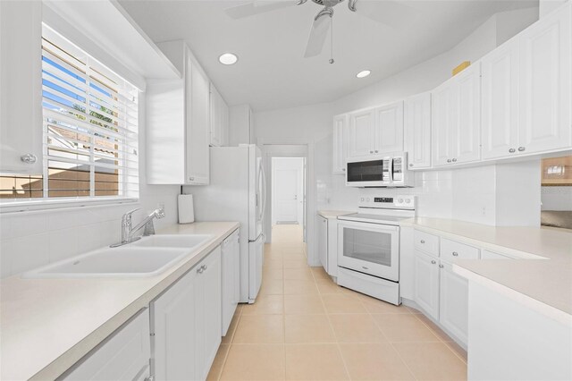 kitchen with white cabinets, white appliances, a sink, and ceiling fan