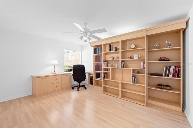 office with light wood-style flooring, baseboards, and a ceiling fan
