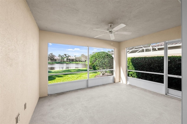 unfurnished sunroom featuring a water view
