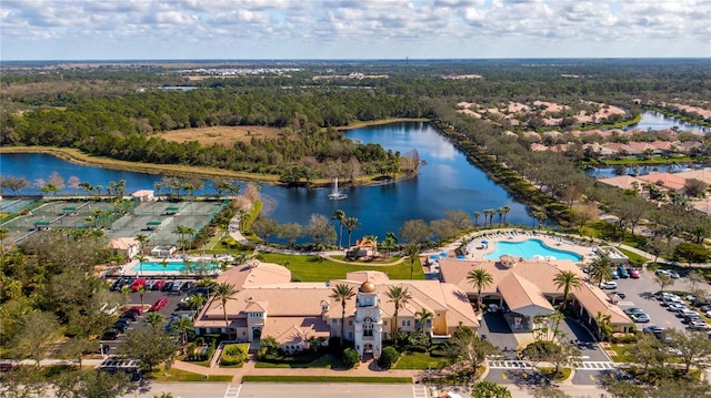 birds eye view of property featuring a water view and a view of trees