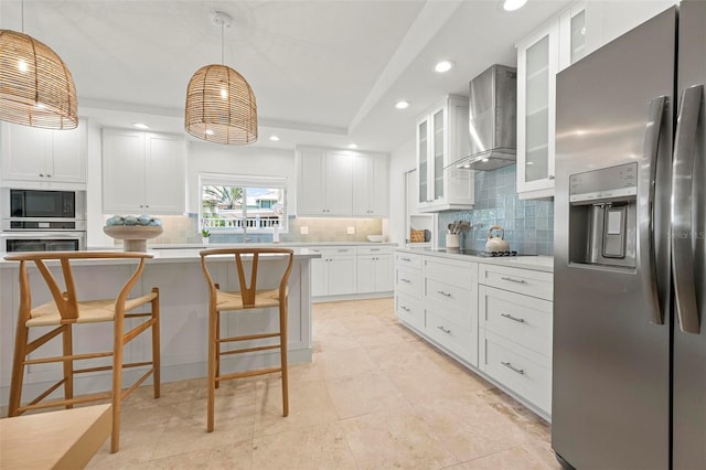 kitchen featuring wall chimney range hood, black appliances, recessed lighting, light countertops, and backsplash