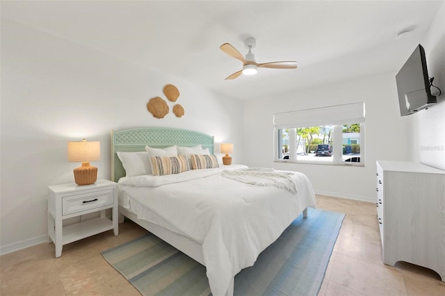 bedroom featuring baseboards, a ceiling fan, and light tile patterned flooring