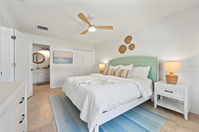 bedroom featuring ceiling fan, baseboards, visible vents, and connected bathroom