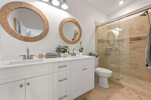 bathroom with a shower stall, a sink, and toilet
