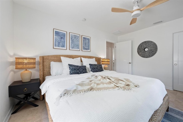 bedroom featuring baseboards, a ceiling fan, and visible vents