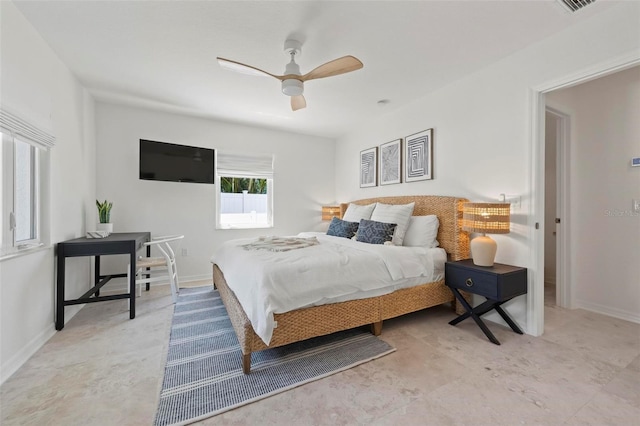 bedroom with baseboards and a ceiling fan