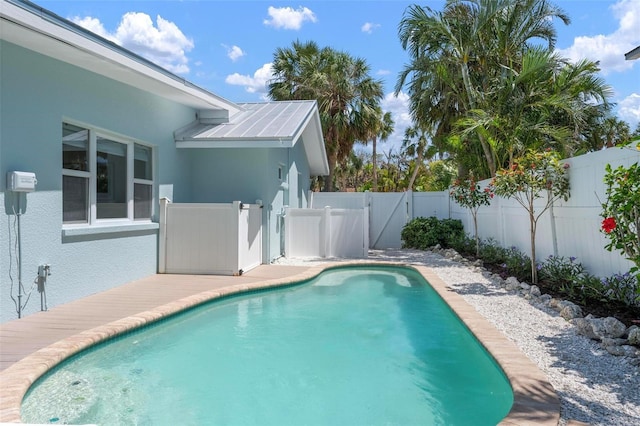 view of pool featuring a fenced backyard, a fenced in pool, and a gate