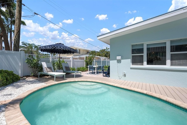 view of pool with a patio, outdoor dining area, and fence