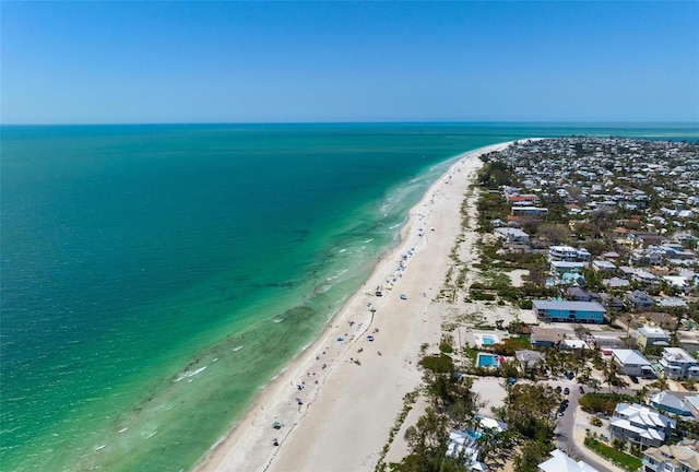 bird's eye view featuring a water view and a beach view
