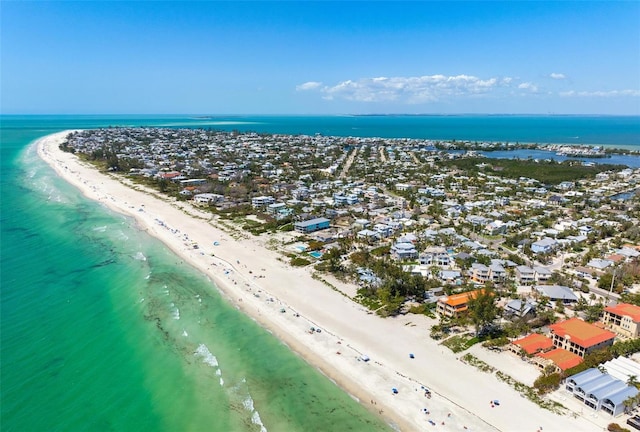 drone / aerial view featuring a water view and a view of the beach