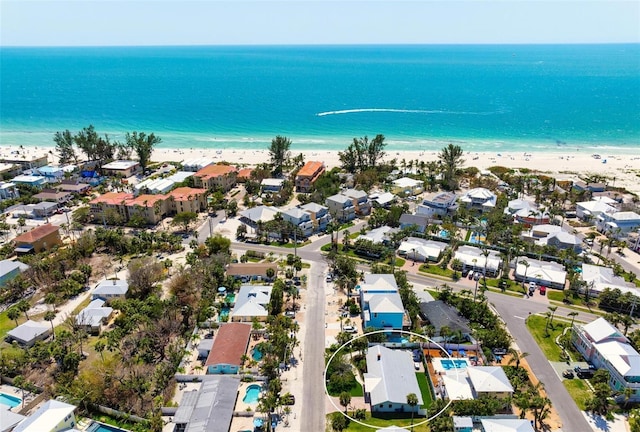 birds eye view of property featuring a beach view, a residential view, and a water view