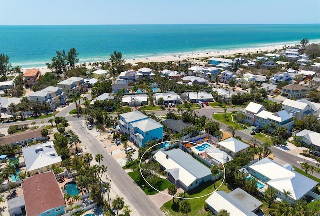 drone / aerial view with a water view and a beach view