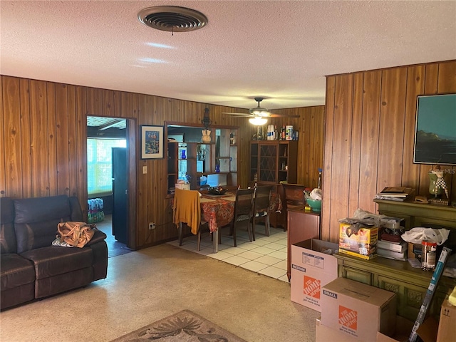 6324 Case Ave, Bradenton, FL 34207 - living room featuring a textured ceiling, wood walls, and ceiling fan