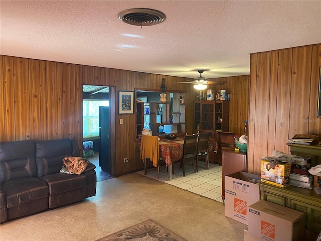 6324 Case Ave, Bradenton, FL 34207 - living area with a textured ceiling, wooden walls, and a ceiling fan