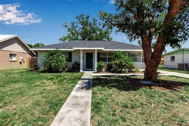 view of front of house featuring a front lawn and fence