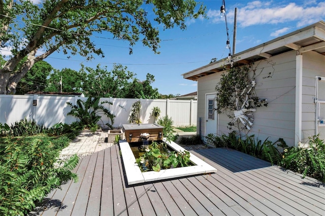 wooden terrace featuring a fenced backyard