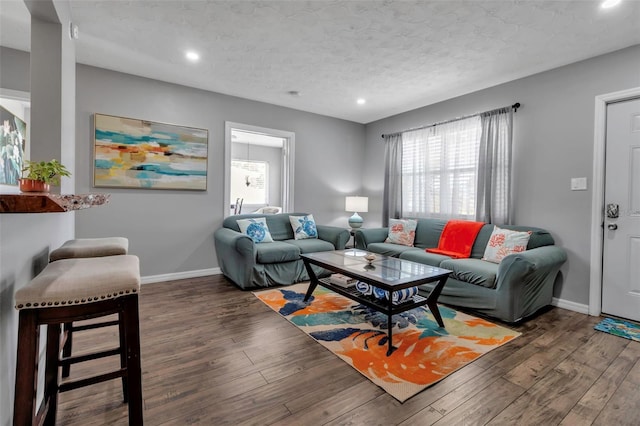 living area with hardwood / wood-style floors, baseboards, and plenty of natural light