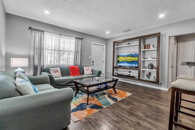living room with visible vents, baseboards, a textured ceiling, dark wood-style floors, and recessed lighting