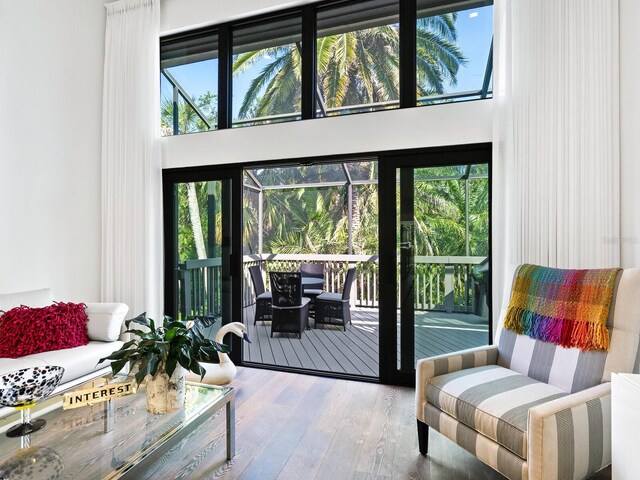 1493 Landings Lake Dr Unit 32, Sarasota, FL 34231 - doorway to outside with plenty of natural light, a high ceiling, and hardwood / wood-style floors