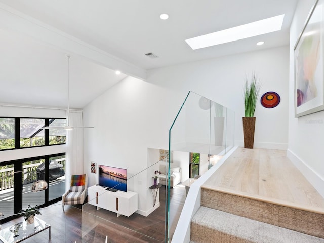 1493 Landings Lake Dr Unit 32, Sarasota, FL 34231 - stairway with wood finished floors, a skylight, beamed ceiling, baseboards, and visible vents