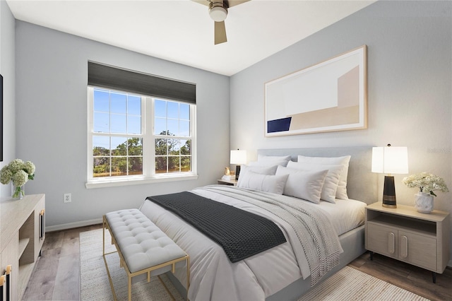 bedroom with baseboards, a ceiling fan, and wood finished floors