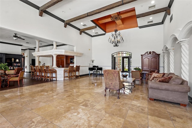 living room with ornate columns, visible vents, ceiling fan, and beam ceiling