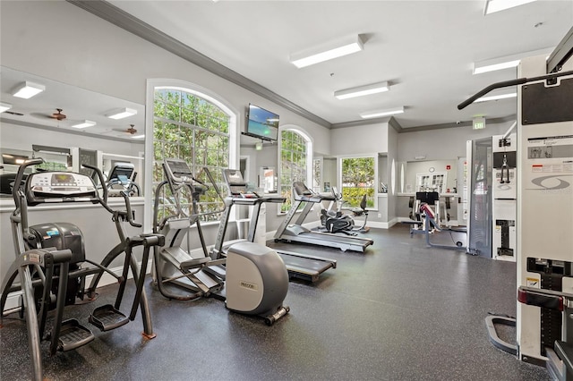 exercise room featuring crown molding and baseboards