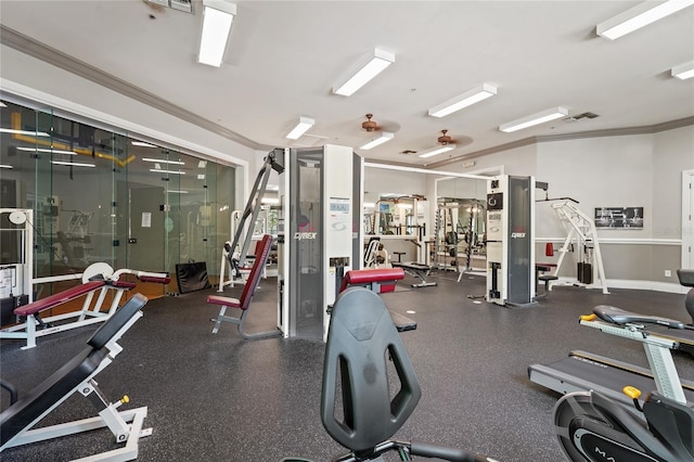 exercise room featuring crown molding, baseboards, and visible vents