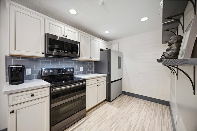 1586 Dorgali Dr, Sarasota, FL 34238 - kitchen featuring appliances with stainless steel finishes, baseboards, light countertops, decorative backsplash, and recessed lighting