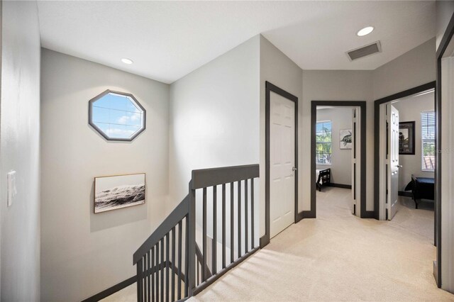 1586 Dorgali Dr, Sarasota, FL 34238 - hall featuring an upstairs landing, light colored carpet, recessed lighting, plenty of natural light, and baseboards
