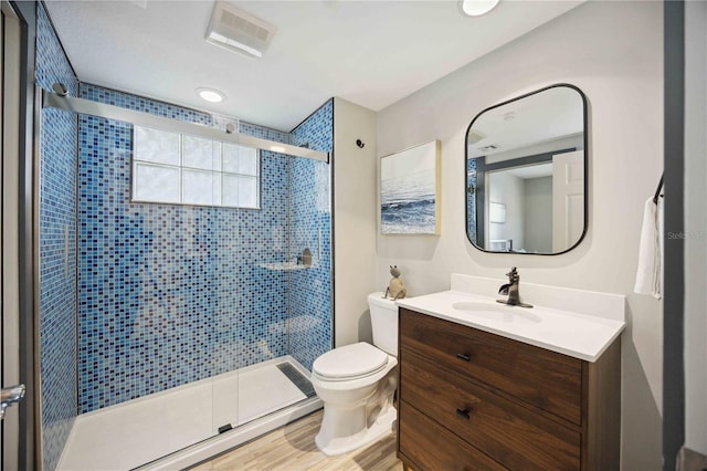 1586 Dorgali Dr, Sarasota, FL 34238 - bathroom with vanity, a shower stall, toilet, and wood finished floors