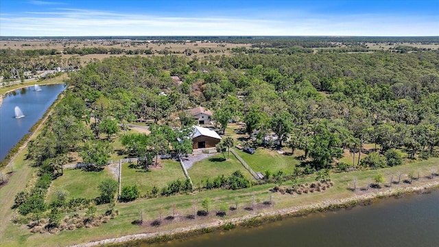 birds eye view of property featuring a water view and a forest view