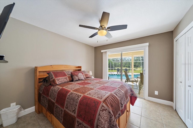 bedroom with access to outside, a closet, light tile patterned floors, and baseboards