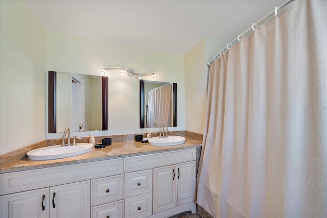 full bathroom with double vanity and a sink