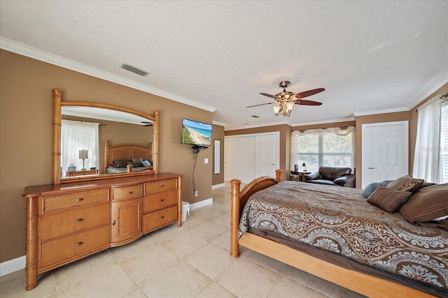 bedroom featuring crown molding, visible vents, baseboards, and light tile patterned floors