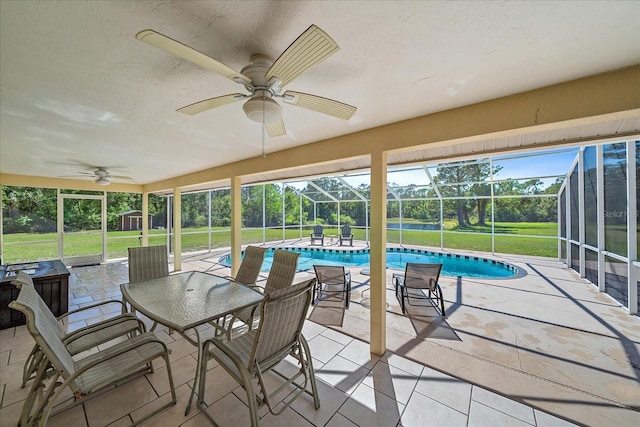 sunroom / solarium with a pool, a ceiling fan, and plenty of natural light