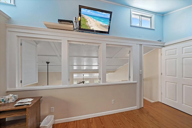 foyer entrance featuring baseboards, a ceiling fan, and wood finished floors