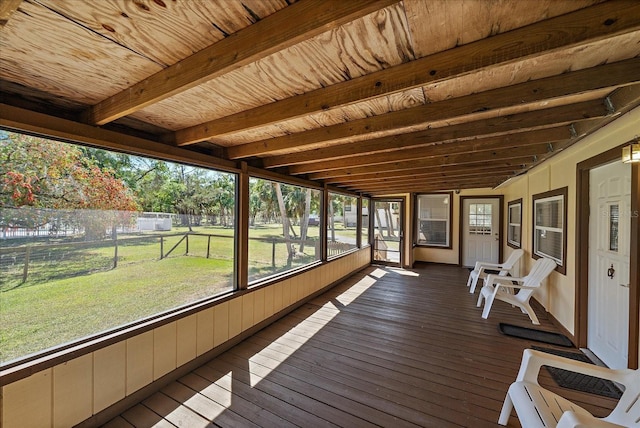 sunroom / solarium featuring beam ceiling