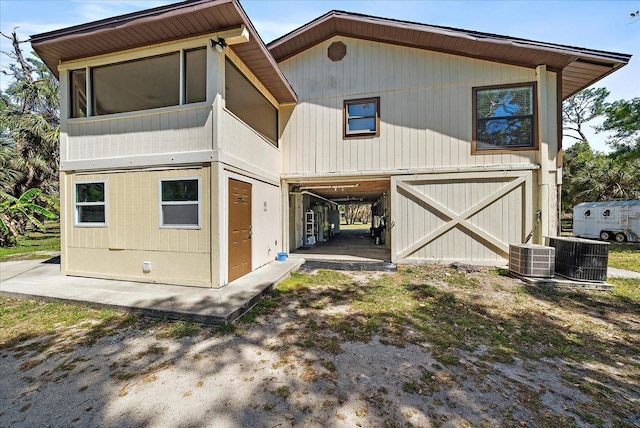 view of front of house featuring cooling unit and an outbuilding