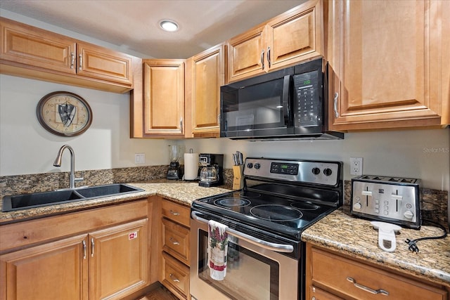 kitchen featuring a sink, black microwave, recessed lighting, electric range, and light stone counters