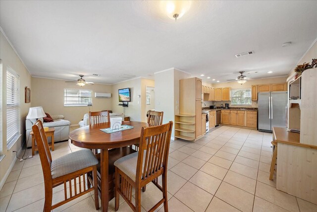 dining room featuring ceiling fan, ornamental molding, visible vents, and light tile patterned floors