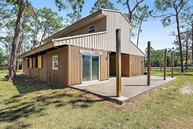 rear view of house featuring a patio and a lawn