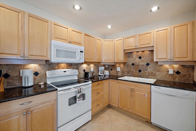 kitchen featuring a sink, light tile patterned floors, white appliances, and light brown cabinets