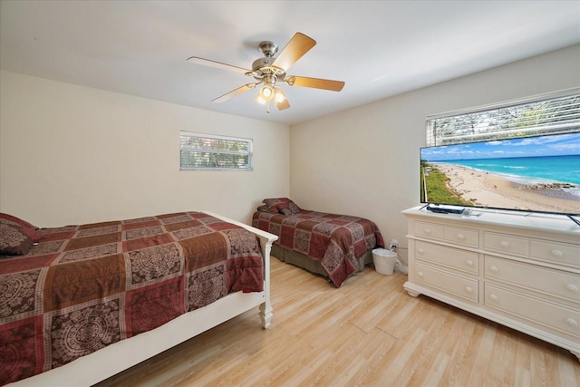 bedroom featuring light wood-type flooring and a ceiling fan