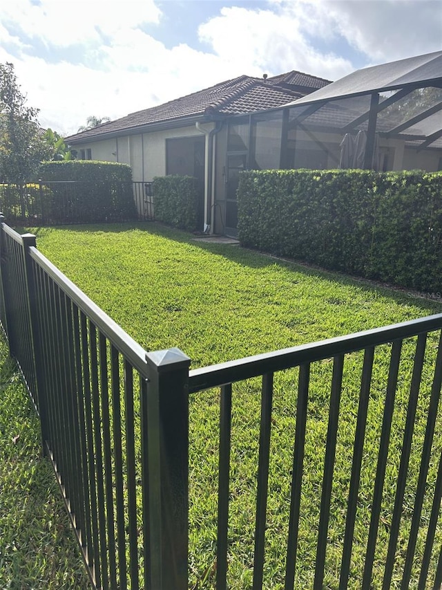 view of yard featuring a lanai and a fenced backyard